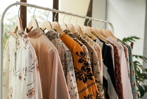 a clothing rack with capsule wardrobe for women, in autumn colors